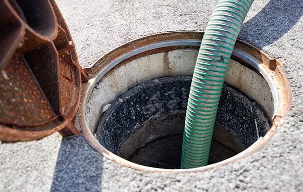 routinely scraping and removing grease, as well as using enzyme-based cleaners, can help maintain a grease trap in between pumpings